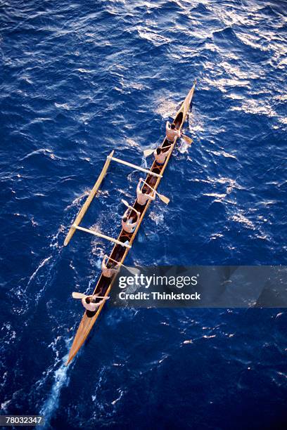 high angle view of a six man outrigger canoe on the ocean. - outrigger stock pictures, royalty-free photos & images