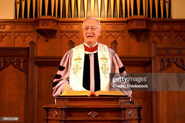 a minister giving a sermon at the pulpit in church. - pulpit stock-fotos und bilder