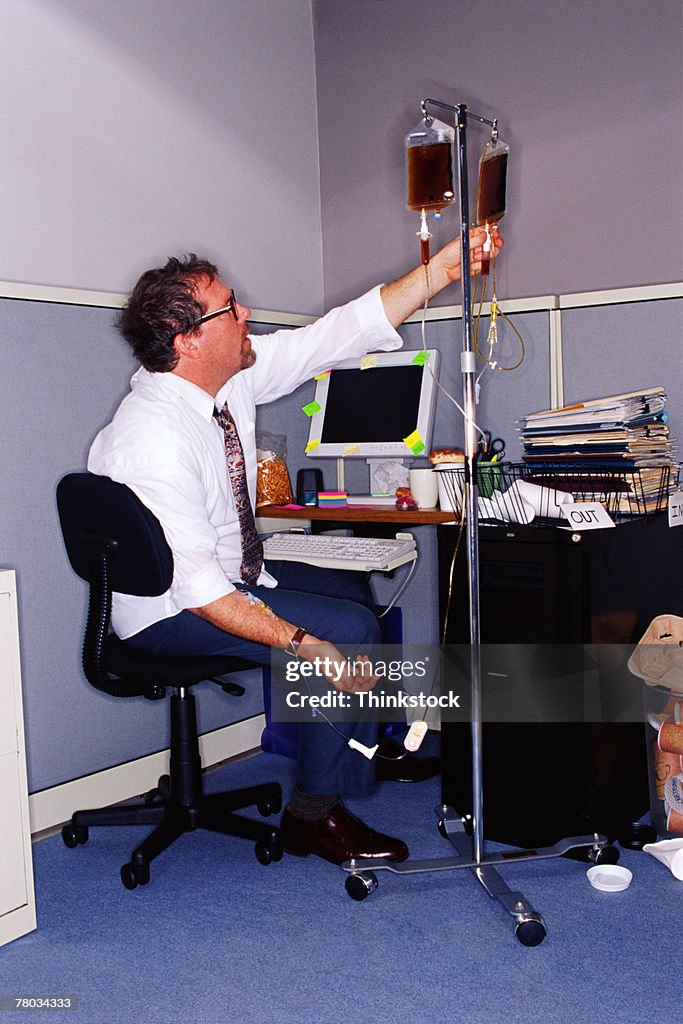 Businessman at messy desk with coffee IV