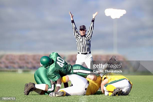 referee signaling touchdown during football game - high school football tackle stock pictures, royalty-free photos & images