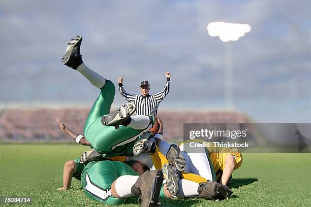 pile up of football players - high school football tackle stock pictures, royalty-free photos & images