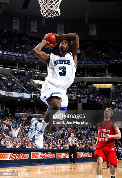 Joey Dorsey of the Memphis Tigers goes up for a dunk against Ryan Wedel of the Arkansas State Indians at FedExForum on November 20, 2007 in Memphis,...