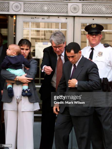 Juan Miguel Gonzalez, front, leaves the Justice Department in Washington D.C. April 7, 2000 with his wife Nercy Carmenate Castillo, six month-old son...