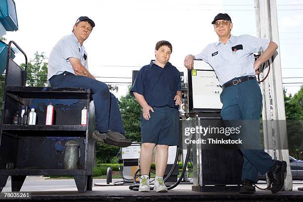 mechanics and boy at gas station - gas pump help stock pictures, royalty-free photos & images