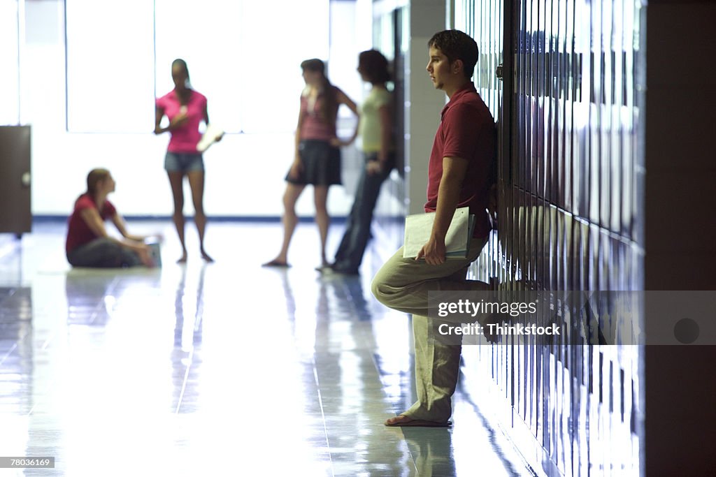 Teenagers in school hallway
