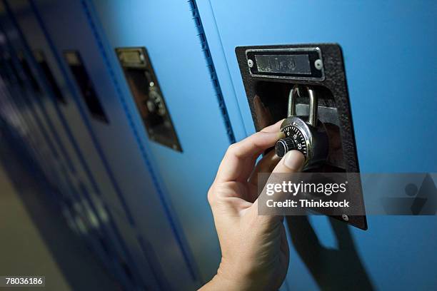 hand turning combination lock - combination lock stock pictures, royalty-free photos & images