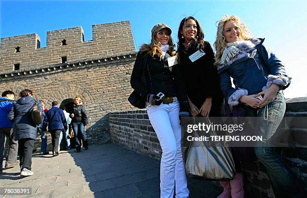 Miss China's Zhang Zilin , Miss Czech republic Sokolova Katerina and Miss Albania's Dushi Elda visit the Badaling section of the Great Wall of China,...