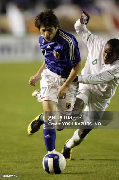 Japan's midfielder Koki Mizuno and Saudi Arabia's midfielder Abdulmalek Abdullah Al Khaibri fight the ball during the Olympic qualifying match...