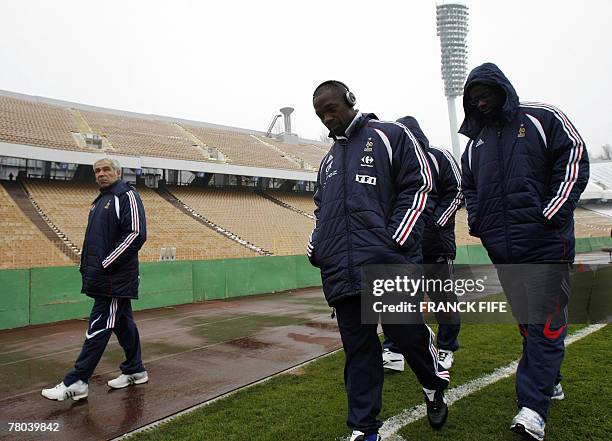 French midfielder Claude Makelele and captain Lilian Thuram walk along the field of the Olympic Stadium, 21 November 2007 in Kiev, before the last...