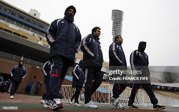 French football player Hatem Ben Arfa walks with teammates along the field of the Olympic Stadium, 21 November 2007 in Kiev, before the last...