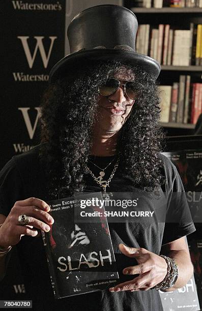 Saul Hudson, also known as 'Slash' former lead guitarist of US band 'Guns N' Roses' and current lead guitarist of the band 'Velvet Revolver,' signs...