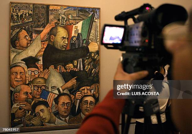 Journalist records the piece Number 17, which his one of the parts of the mural paint "Mussolini", created by Mexican artist Diego Rivera, during a...