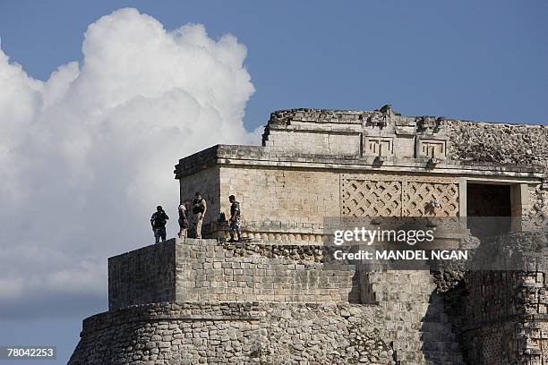 Secret Service agents stand watch atop a pyramid as US President George W. Bush and Mexican President Felipe Calderon tour the Uxmal ruins in Uxmal,...