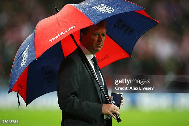 Steve McClaren manager of England looks on from under his umbrella prior to the Euro 2008 Group E qualifying match between England and Croatia at...