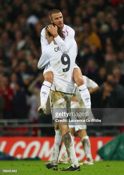 Peter Crouch of England celebrates with David Beckham after scoring England's 2nd and the equalising goal during the Euro 2008 Group E qualifying...