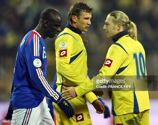 France's captain Lilian Thuram talks with Ukraine's captain Andriy Shevchenko and teammate Andriy Voronim during their Euro 2008 qualifying football...