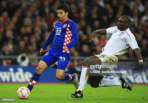 Sol Campbell of England slides in on Da Silva Eduardo of Croatia during the Euro 2008 Group E qualifying match between England and Croatia at Wembley...