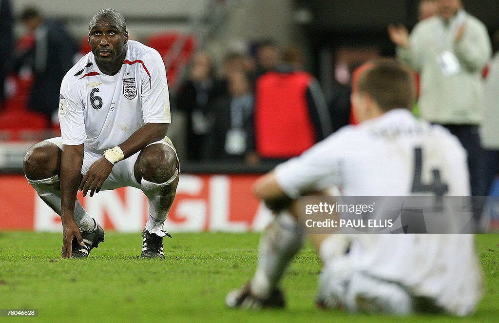 England footballers Sol Campbell (L) and