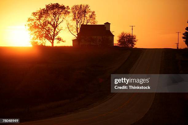 silhouette of farmhouse at sunset - iowa house stock pictures, royalty-free photos & images