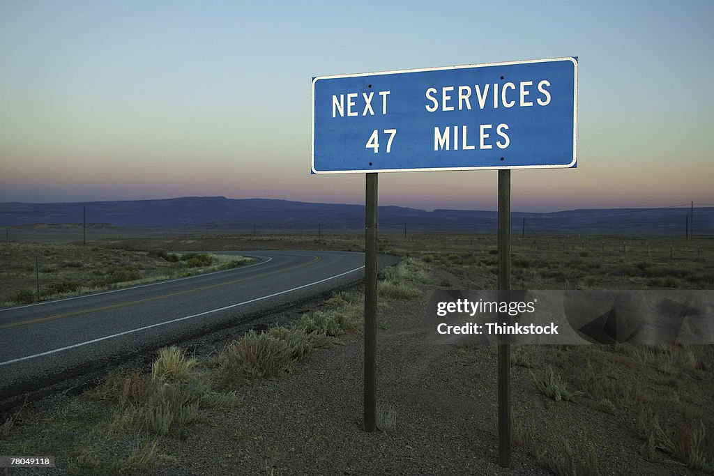 Road sign with distance to next services