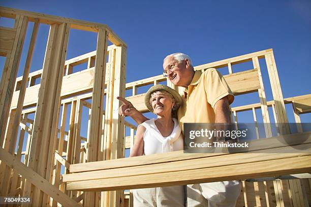 couple at new home construction site - north carolina v south carolina stock pictures, royalty-free photos & images