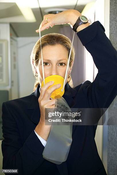 flight attendant with an oxygen mask - maschera per l'ossigeno foto e immagini stock