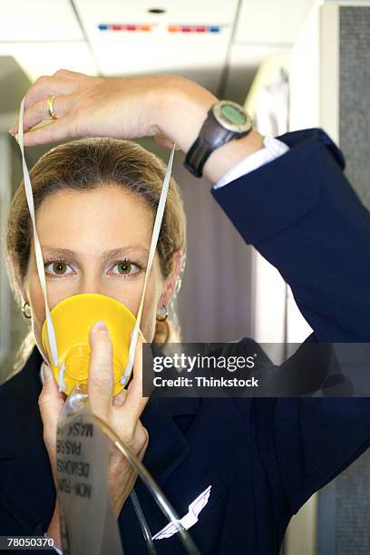flight attendant with an oxygen mask - gasmask bildbanksfoton och bilder