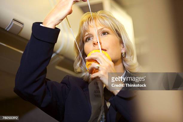flight attendant with an oxygen mask - oxygen mask stock pictures, royalty-free photos & images