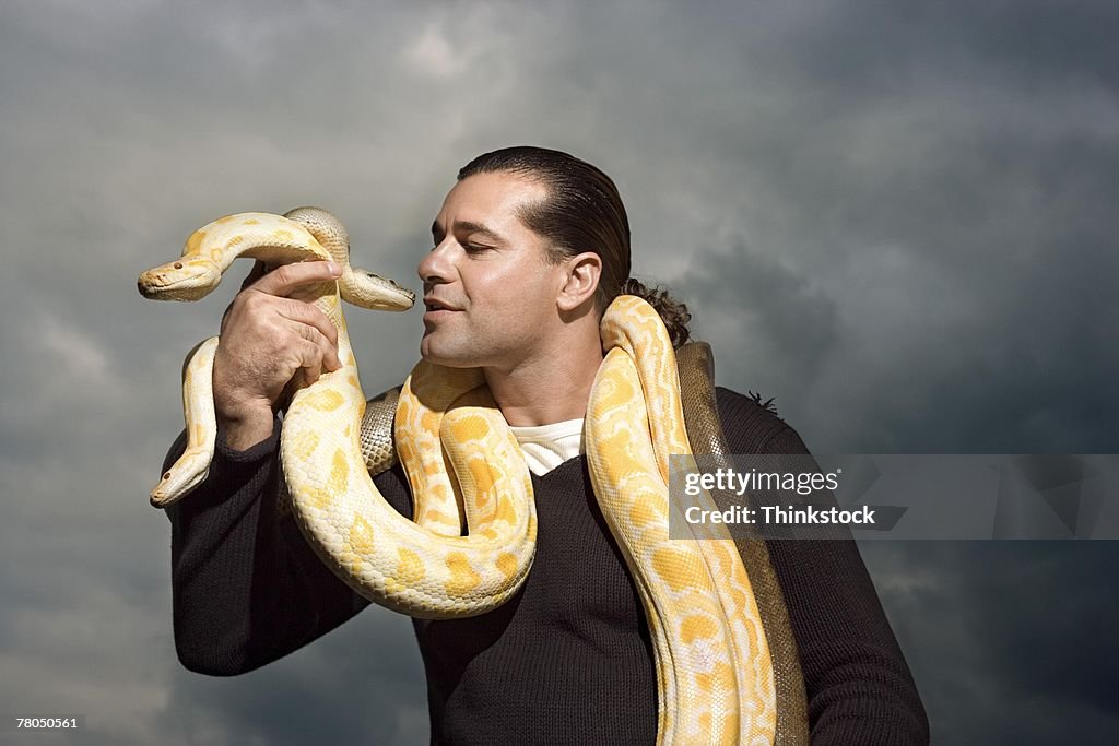 Man with snakes around neck