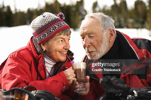 couple outdoors with coffee - senior winter sport stock pictures, royalty-free photos & images