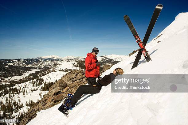 ski patrol helping injured person - ski patrol stock-fotos und bilder