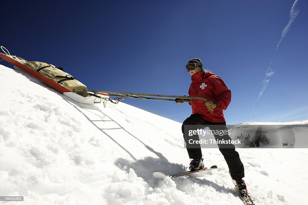 Ski patrol pulling supplies on sled