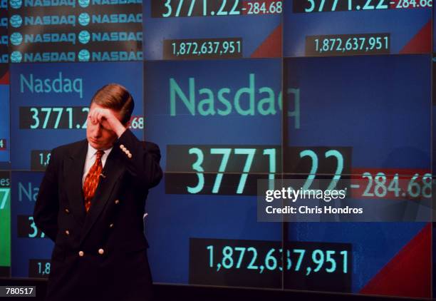 Television correspondent Tom Costello wipes his brow before going on the air at the Nasdaq MarketSite in New York City just after the close of...