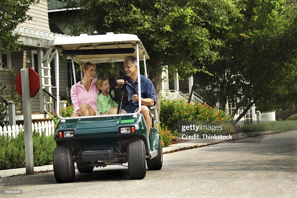 Family in golf cart
