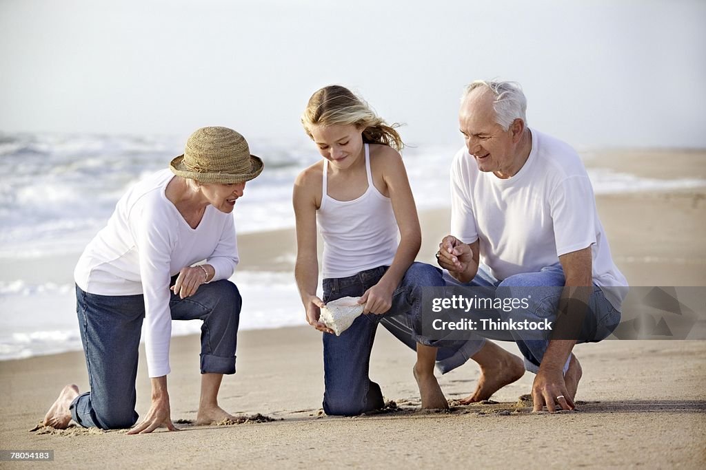 Grandparents at beach with granddaughter