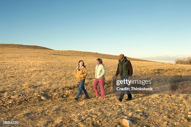 family walking in field - laramie bildbanksfoton och bilder