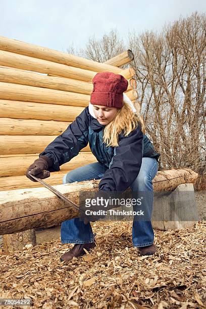 teenage girl building log cabin - laramie project foto e immagini stock