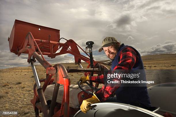 man posing on tractor - laramie bildbanksfoton och bilder