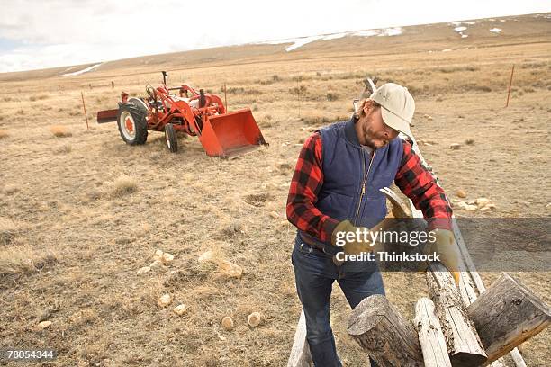 man repairing fence - laramie stock pictures, royalty-free photos & images