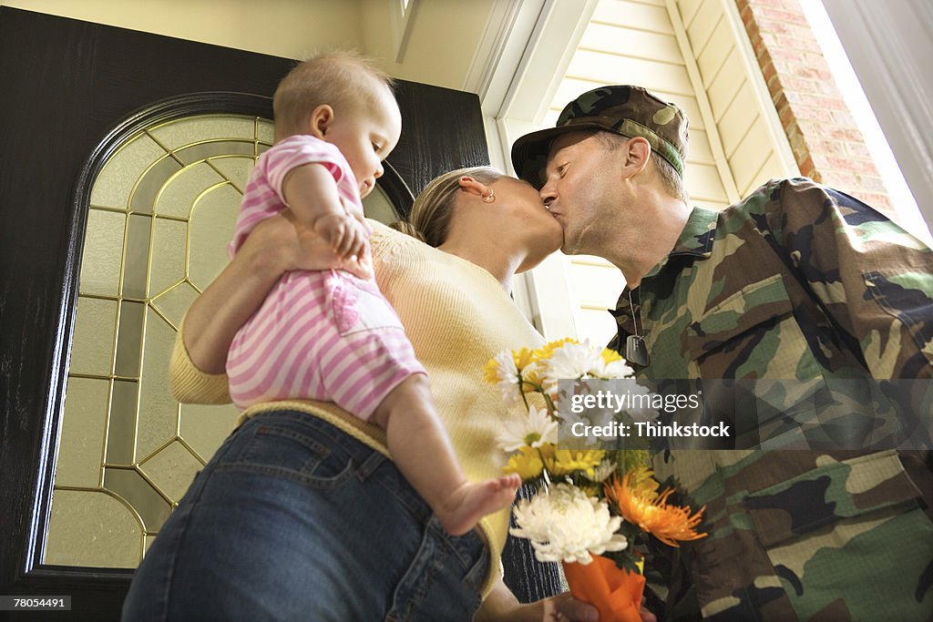 Soldier kissing wife