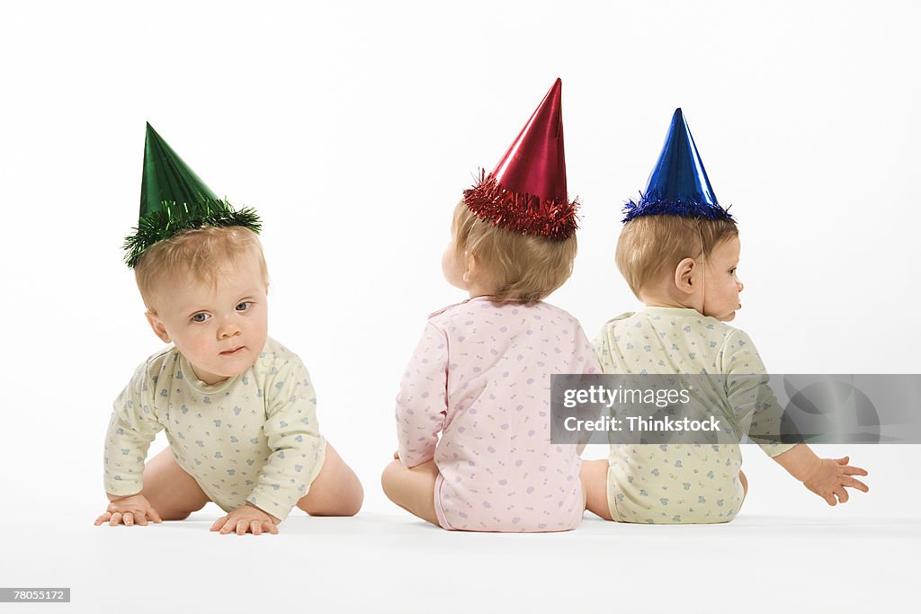 Babies in party hats