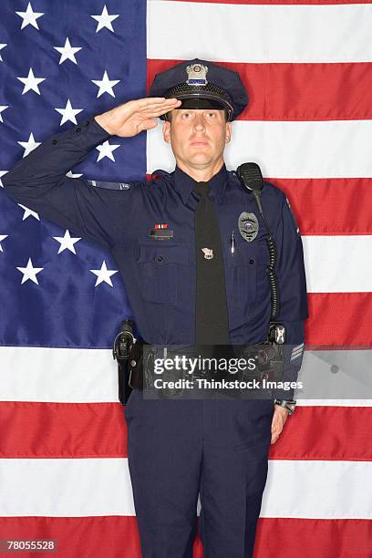 police officer saluting and american flag - police saluting stock pictures, royalty-free photos & images