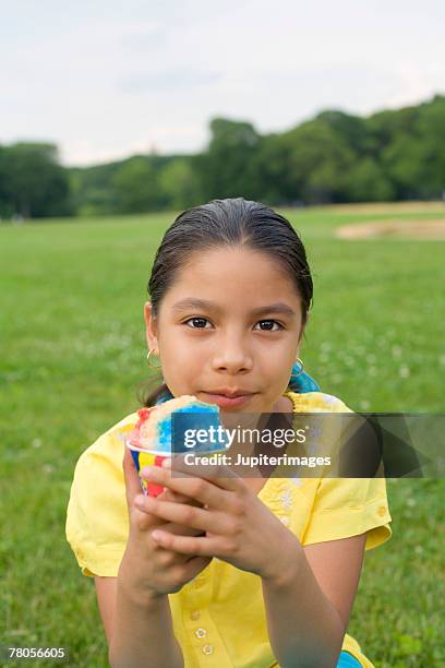 girl in park with icy treat - snow cones shaved ice stock pictures, royalty-free photos & images