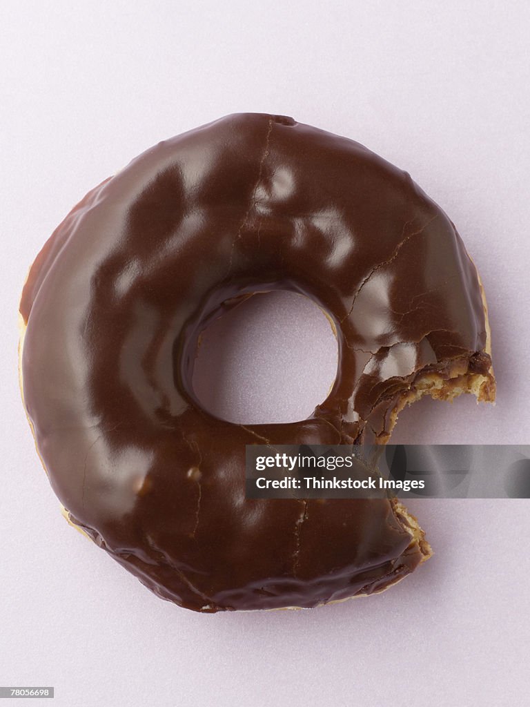 Partially eaten chocolate donut