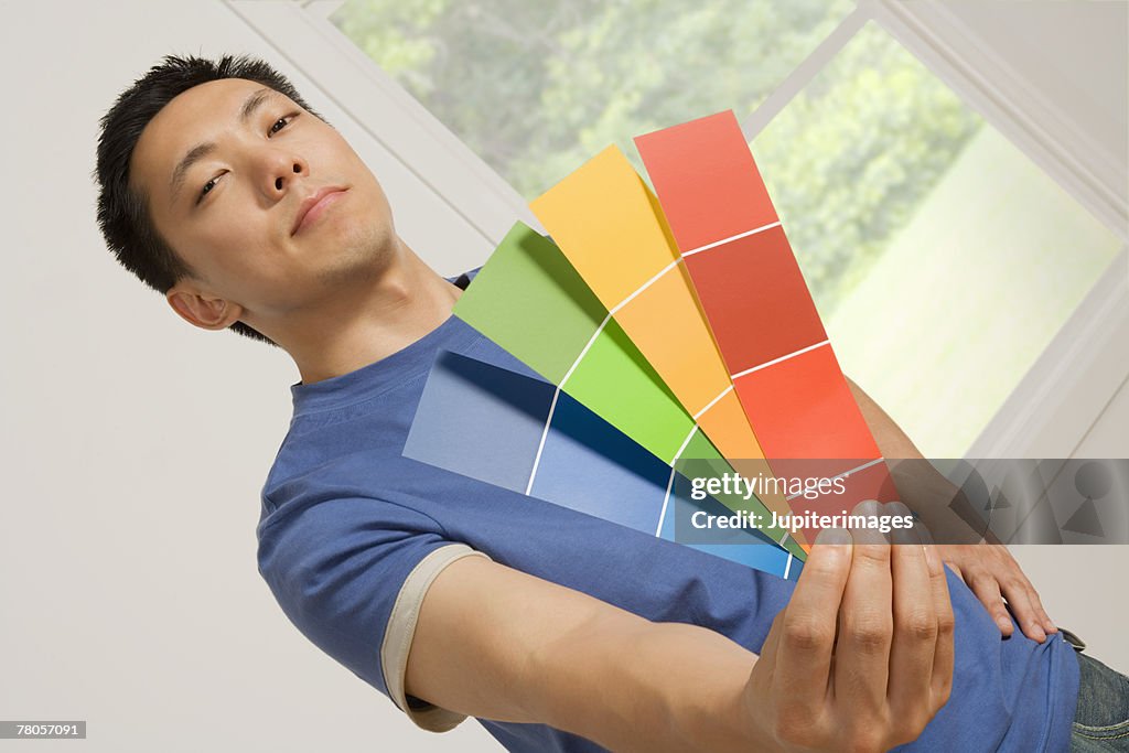 Man holding paint samples
