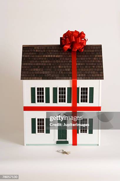 miniature house with ribbon and bow on it - dolls house stock pictures, royalty-free photos & images