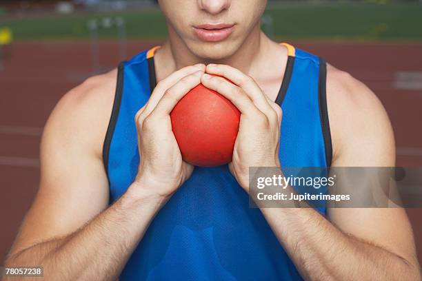 athlete holding shot put - shot put stock pictures, royalty-free photos & images