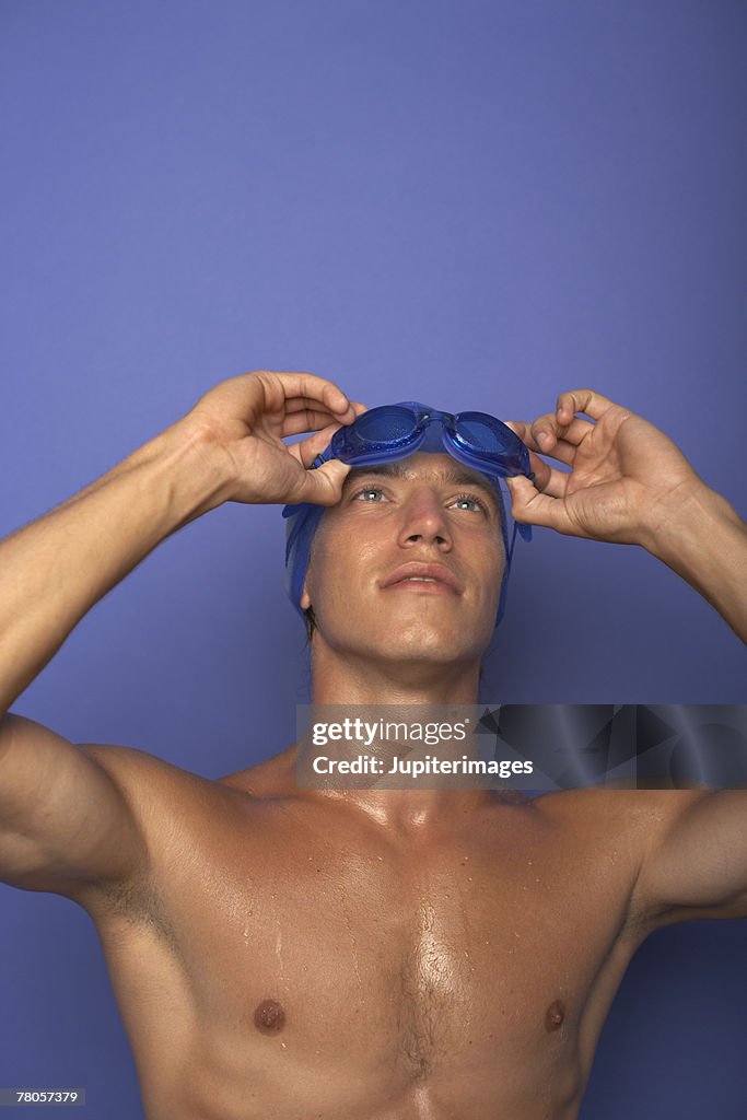 Man in swim cap and goggles and swimsuit