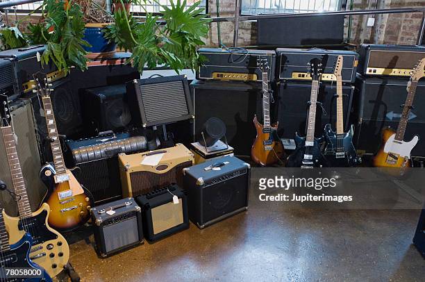guitars in music store - guitar shop stock pictures, royalty-free photos & images