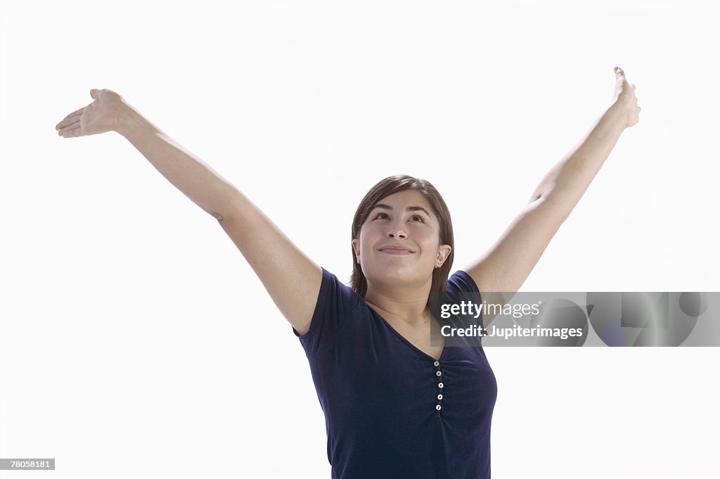 Smiling woman with arms outstretched